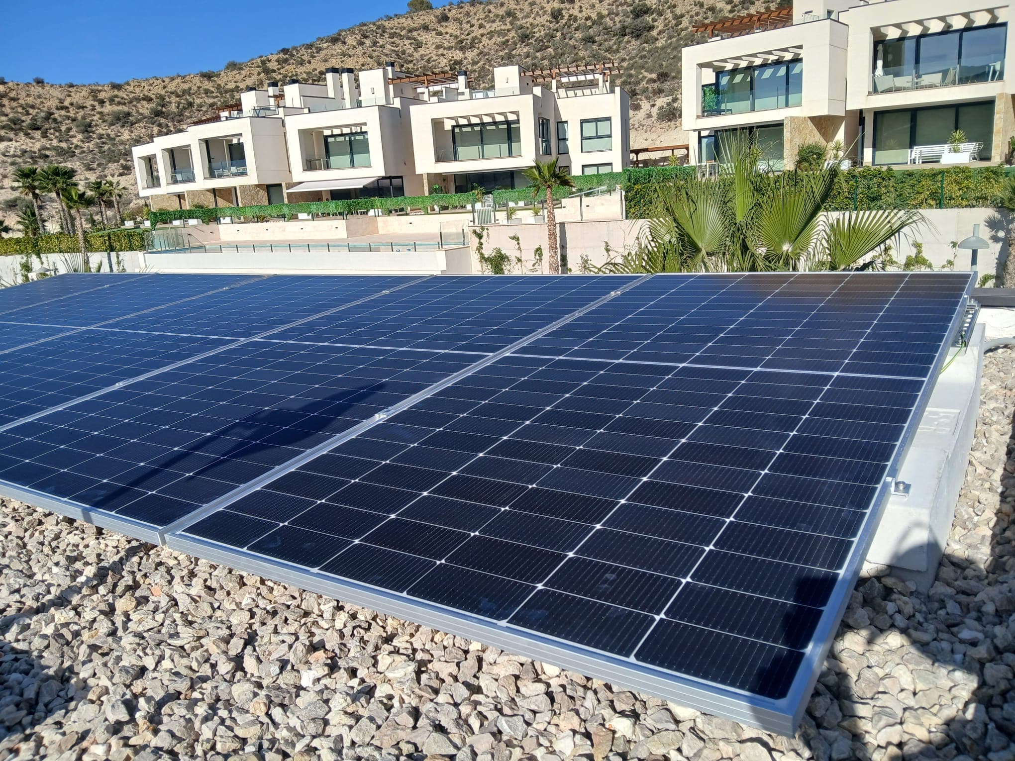 Panels being fitted on a flat roof above the coast